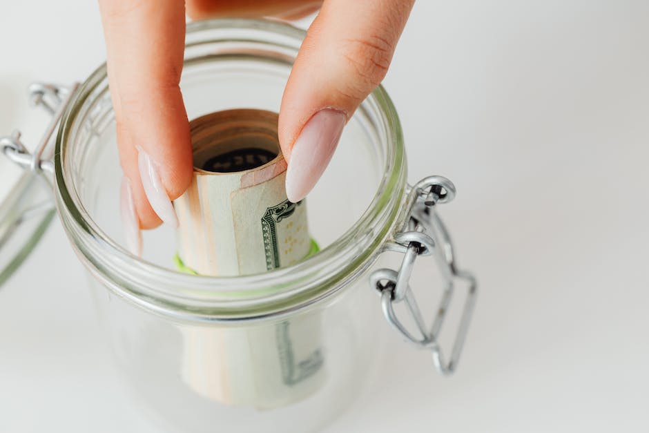 Image of a person holding a money jar, representing loans in Germany.